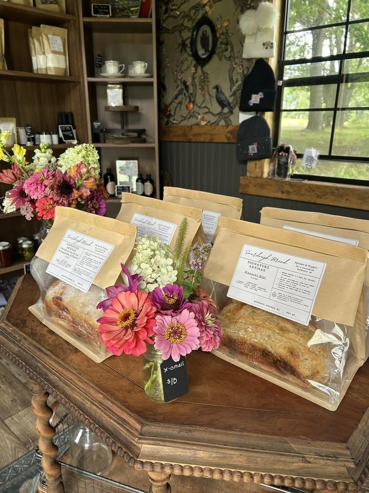 Interior of Sprout & Pepper self-serve mercantile with artisan sourdough loaves and fresh flowers in Buchanan, Michigan